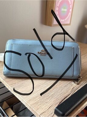SOLD
Coach Light Blue Saffiano Zip Wallet with Gold Logo
